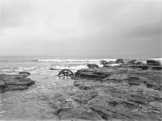 Old tram wheels in the tide by peterdegraaff