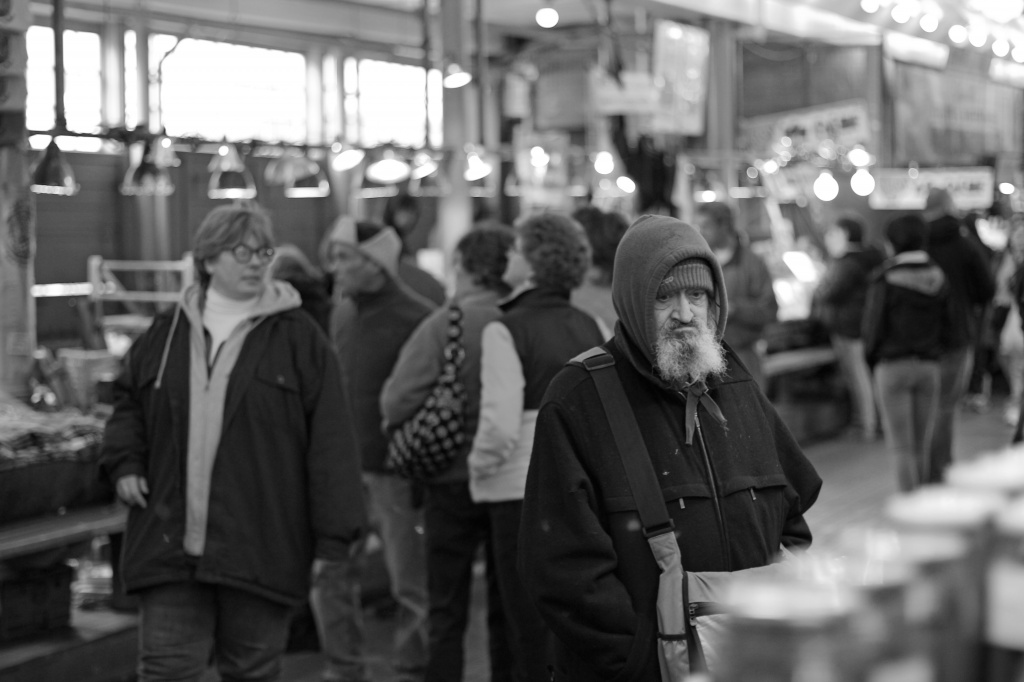 He Stood Out In The Crowd Of Shoppers At The Market by seattle
