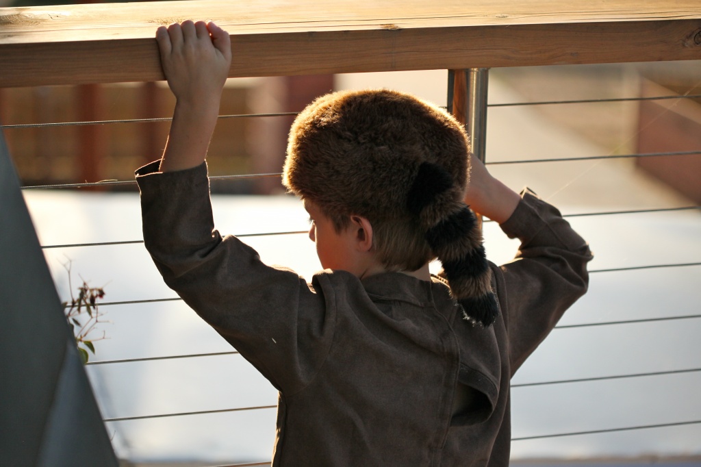 My nephew watching his new neighbours from his balcony. I love his Davey Crockett outfit. by lbmcshutter