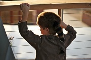 30th Apr 2011 - My nephew watching his new neighbours from his balcony. I love his Davey Crockett outfit.