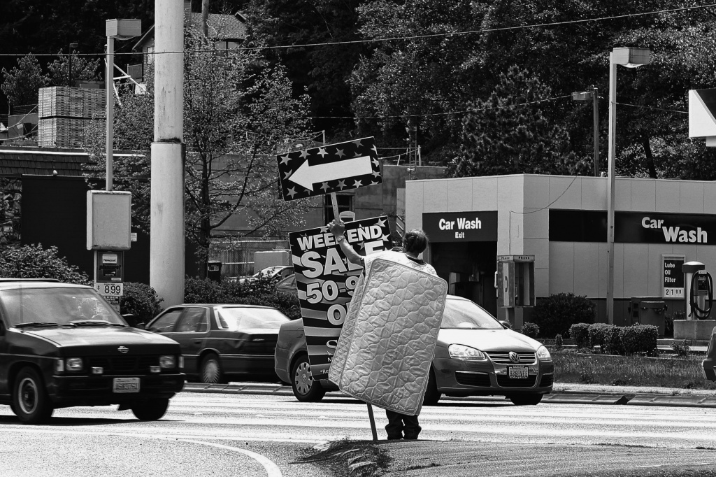Here He Comes To Save The Day, Mattress Man Is On His Way! by seattle