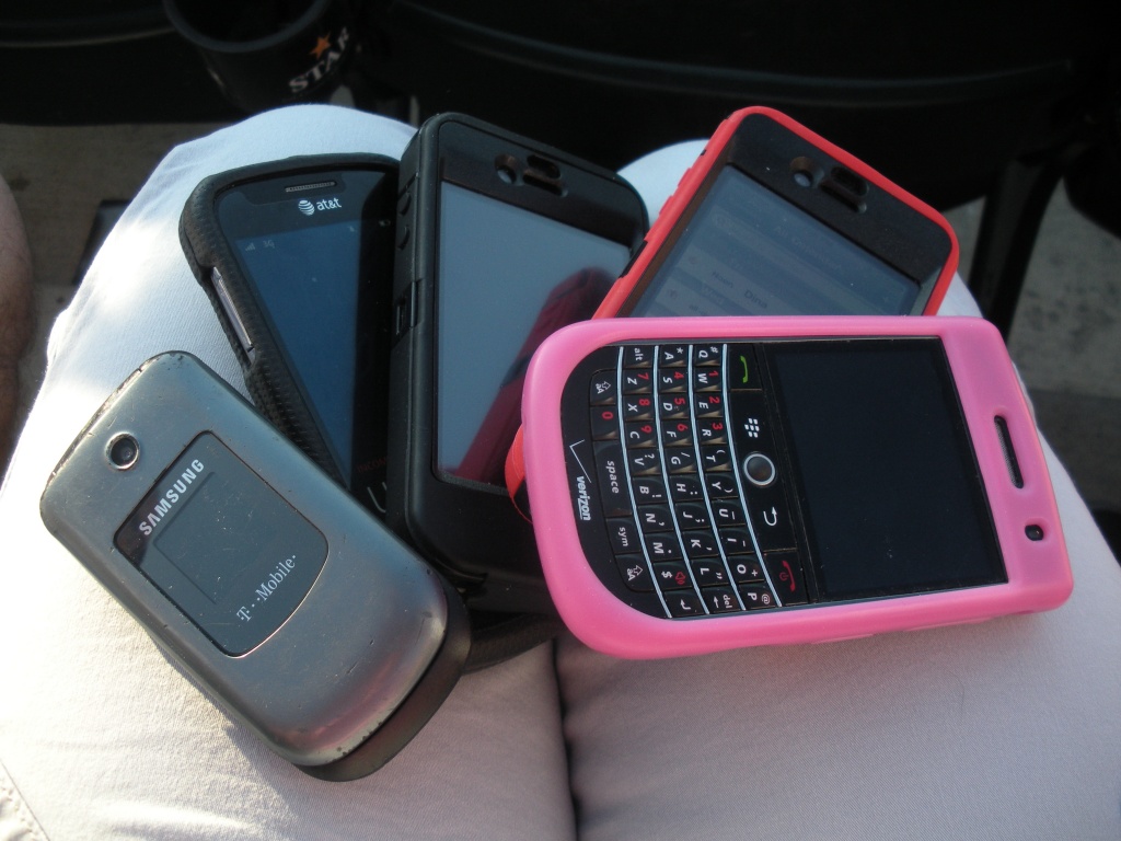 5 Cell Phones in my purse by graceratliff