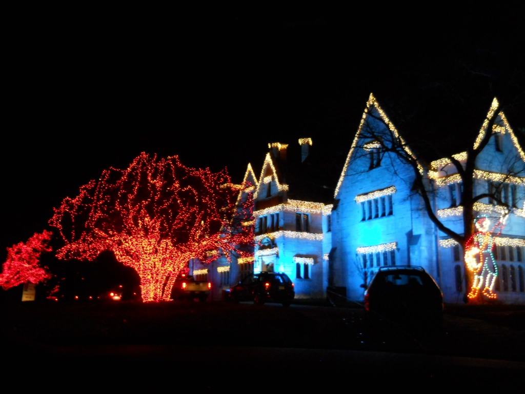 Wider shot of lighted mansion by mittens