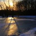Sunset over frozen pond by skipt07