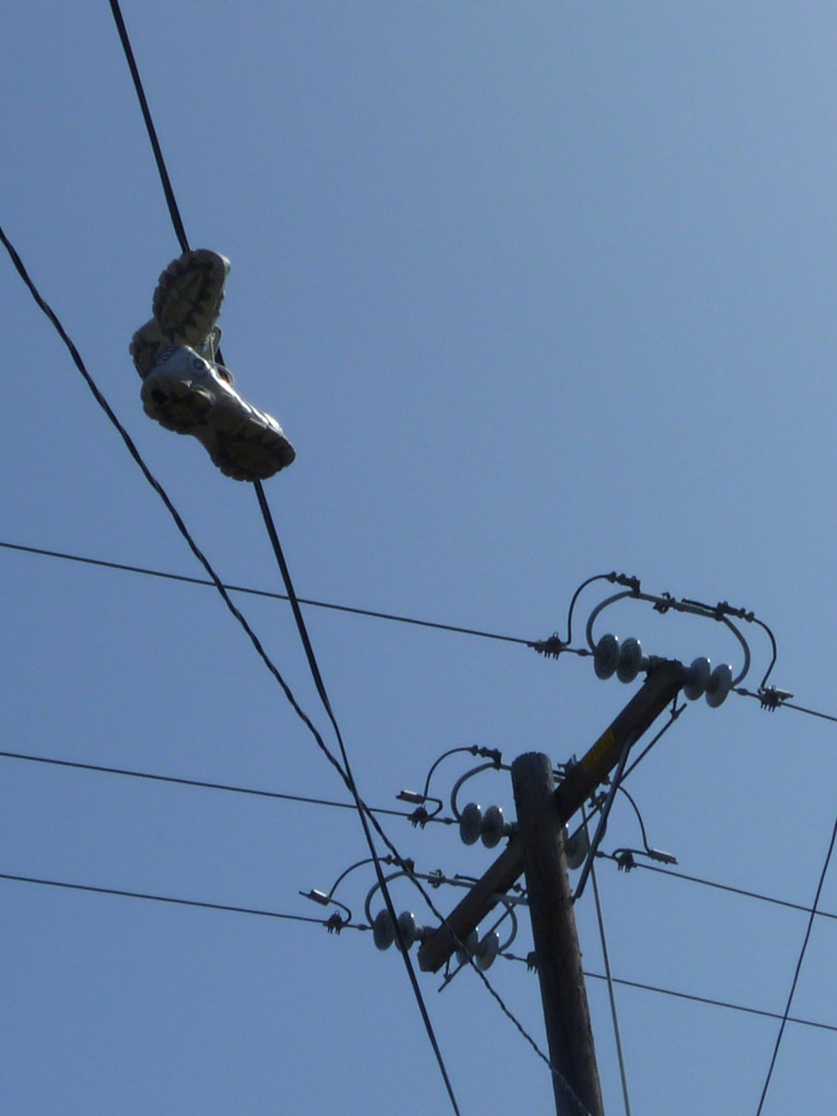 Shoes Hanging from Telephone Line by handmade