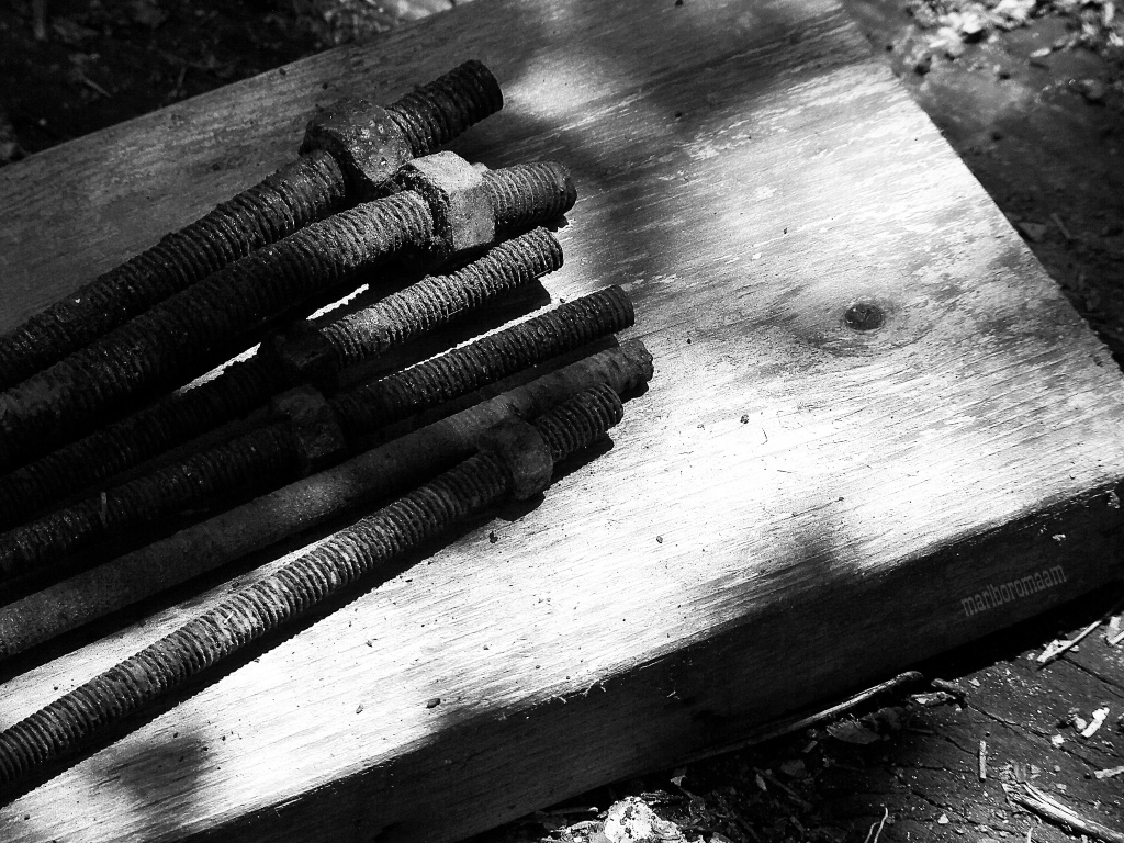 Black and white version of rusty nuts and wood... by marlboromaam