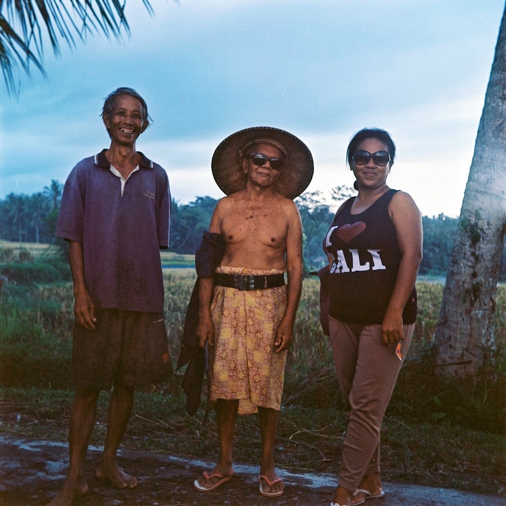 Rice field farmers at sunset by peterdegraaff