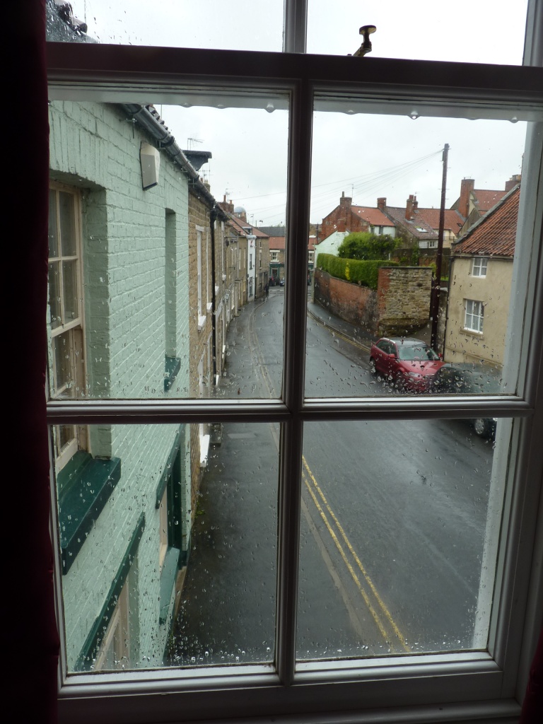 Wet street through a rainy window by lellie