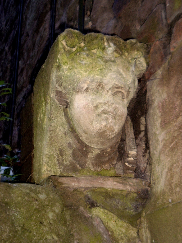 Carved stone head by snowy
