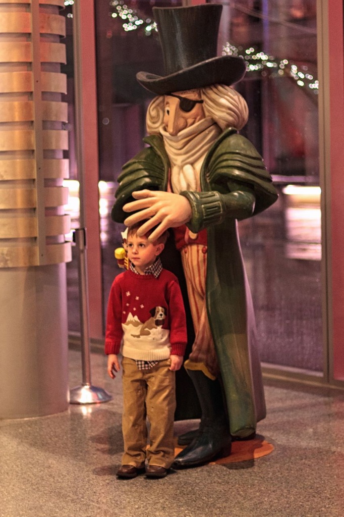 A Little Boy In The Dreaded Christmas Sweater Being Protected By Herr Drosselmeyer From The Nutcracker. by seattle