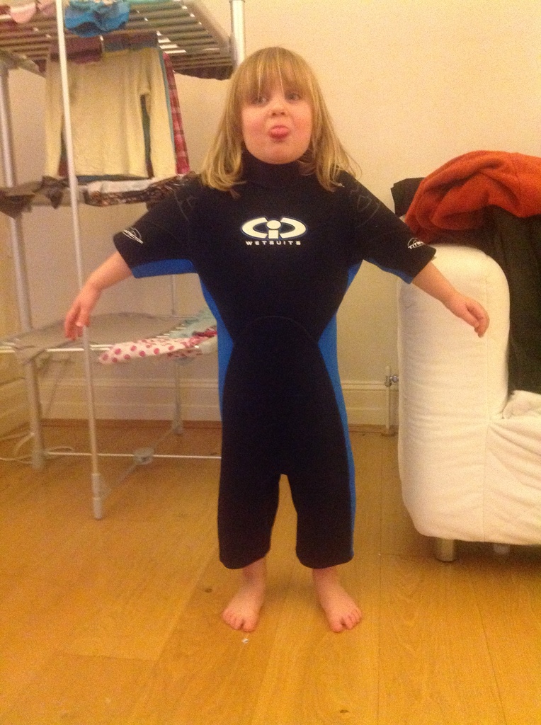 Milly trying on Sam's old wetsuit. by tallgate