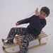 James in his new ski trousers tobogganing properly! by tallgate