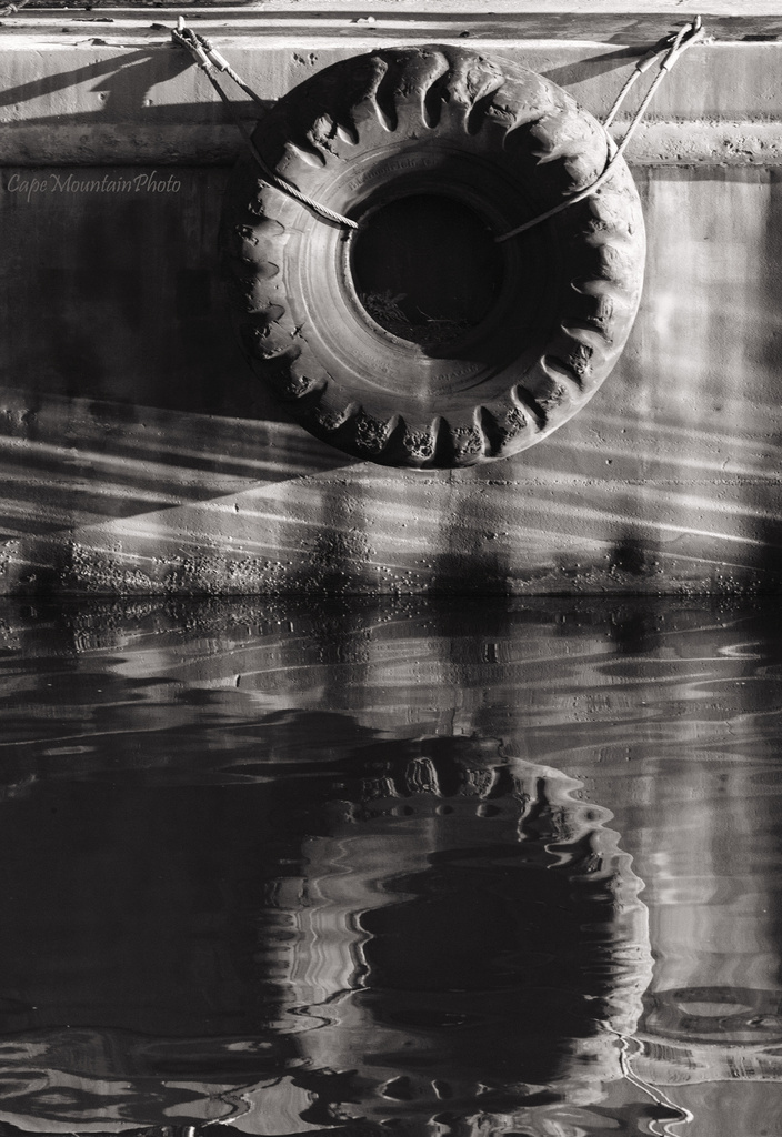 Old Tire Reflections by jgpittenger