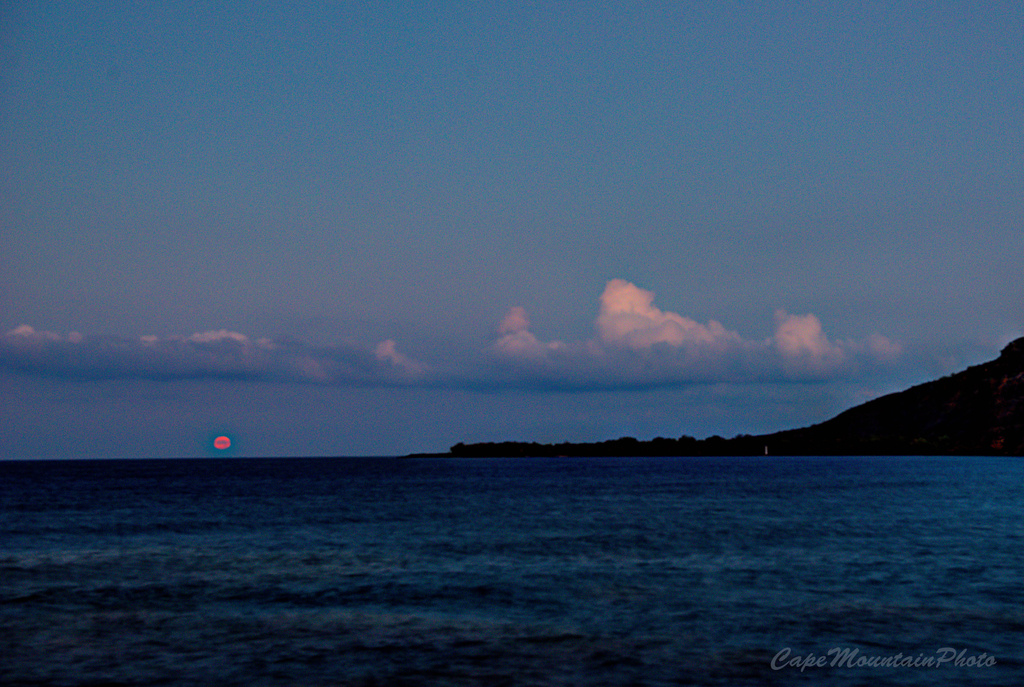 Red Full Moon Setting Into Kealakekua Bay  by jgpittenger