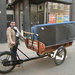 A man with a `` Bakfiets`` moving funiture by pyrrhula