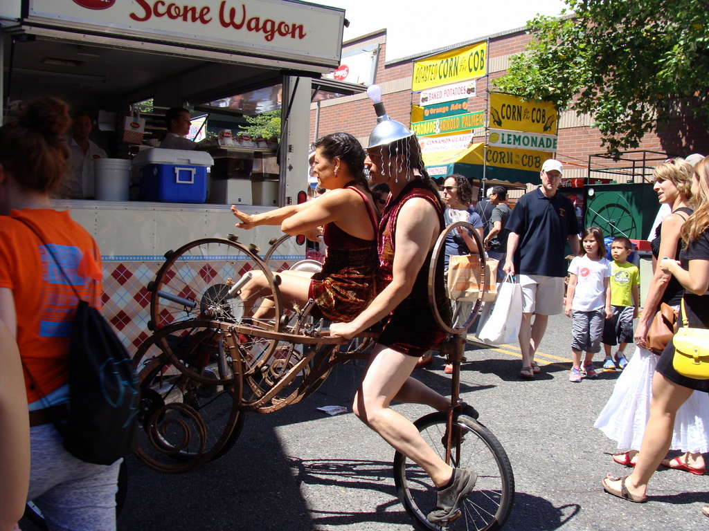 Quirky bike and riders at the Art Fair by princessleia