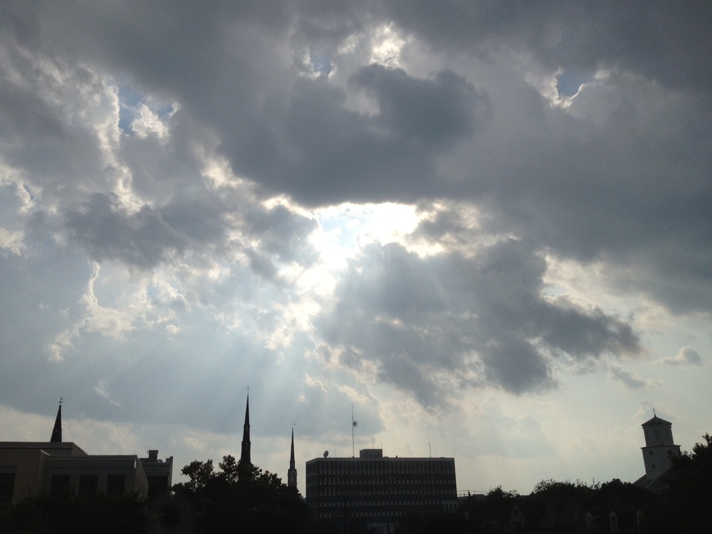 Skies over downtown Charleston with sun rays. by congaree
