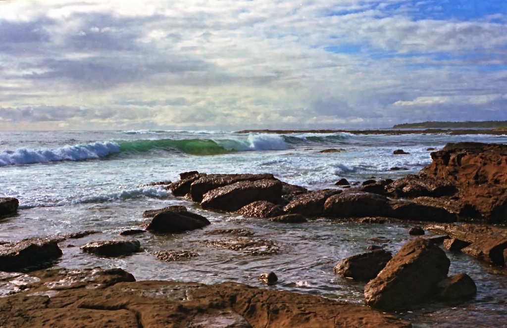 Low tide, rocks and waves by peterdegraaff