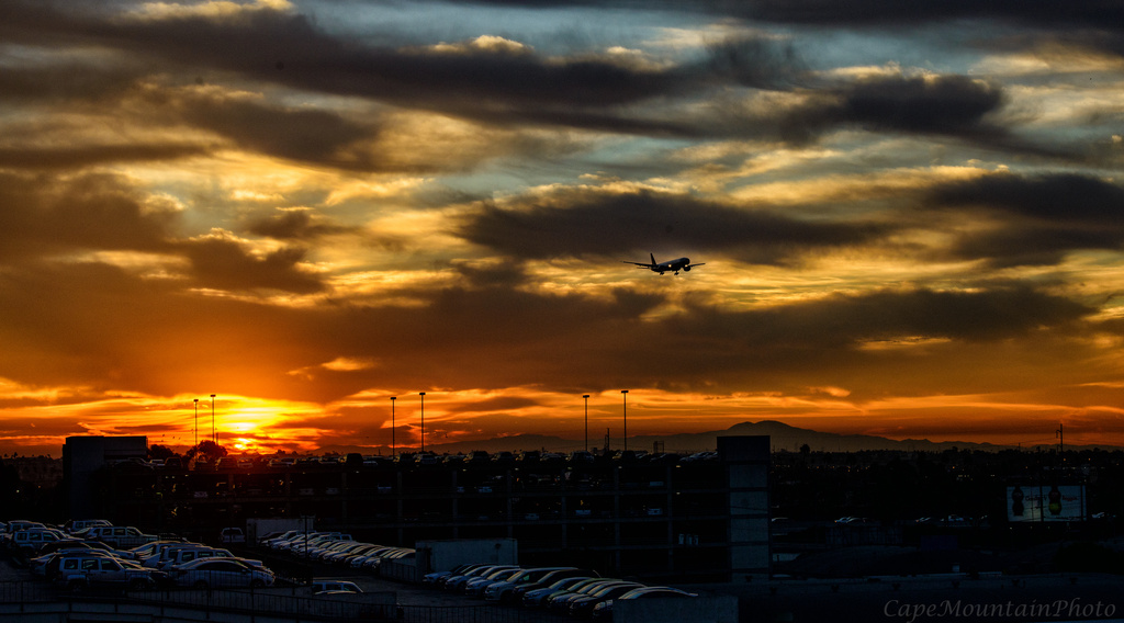 Airplane Flying Out of the Sunrise by jgpittenger