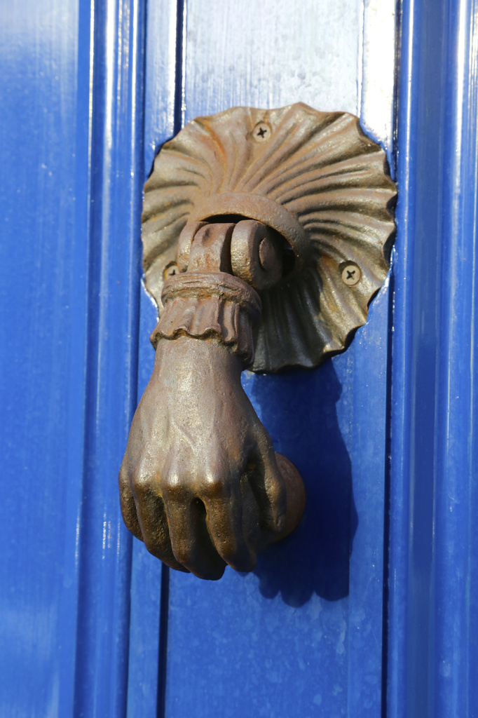 Handful of knocker by padlock