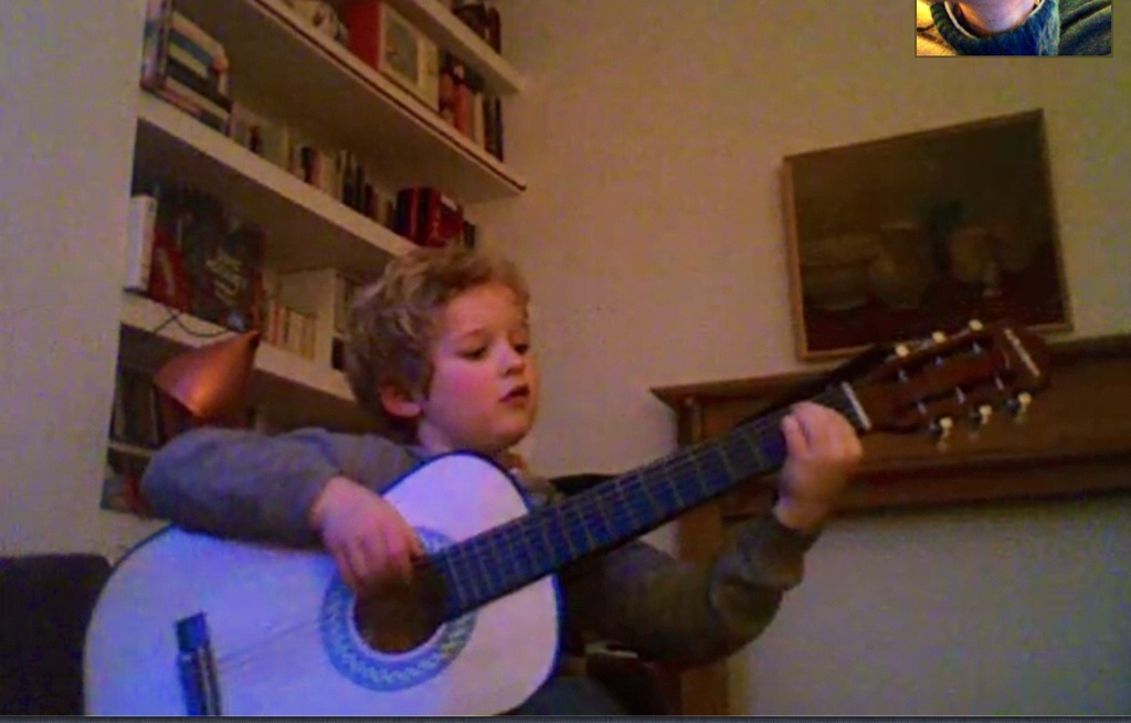 Lucien strumming his dad's guitar on Skype by foxes37