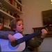 Lucien strumming his dad's guitar on Skype by foxes37