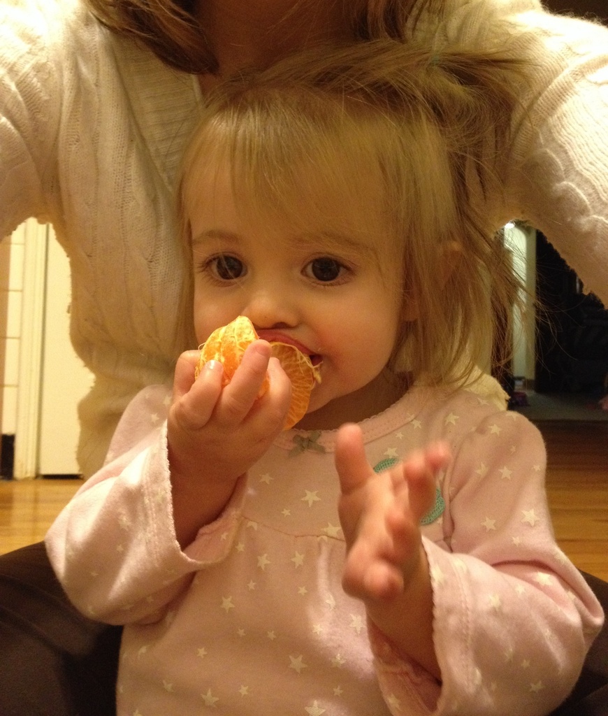 Eating her orange like an apple by mdoelger
