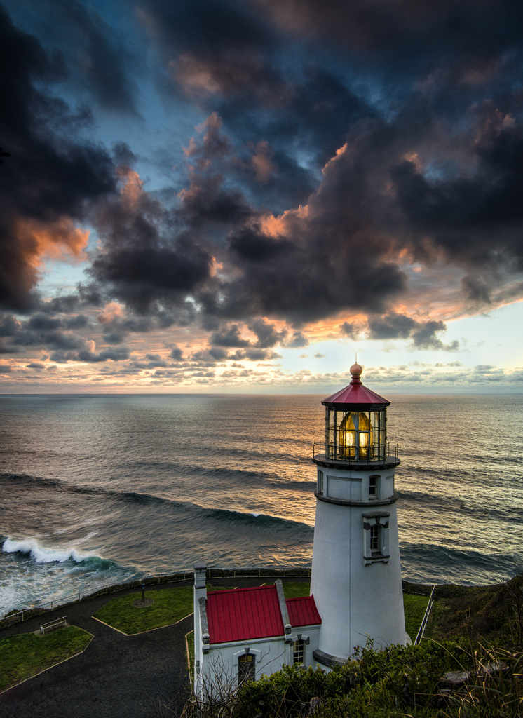 Vertical Lighthouse At Sunset by jgpittenger