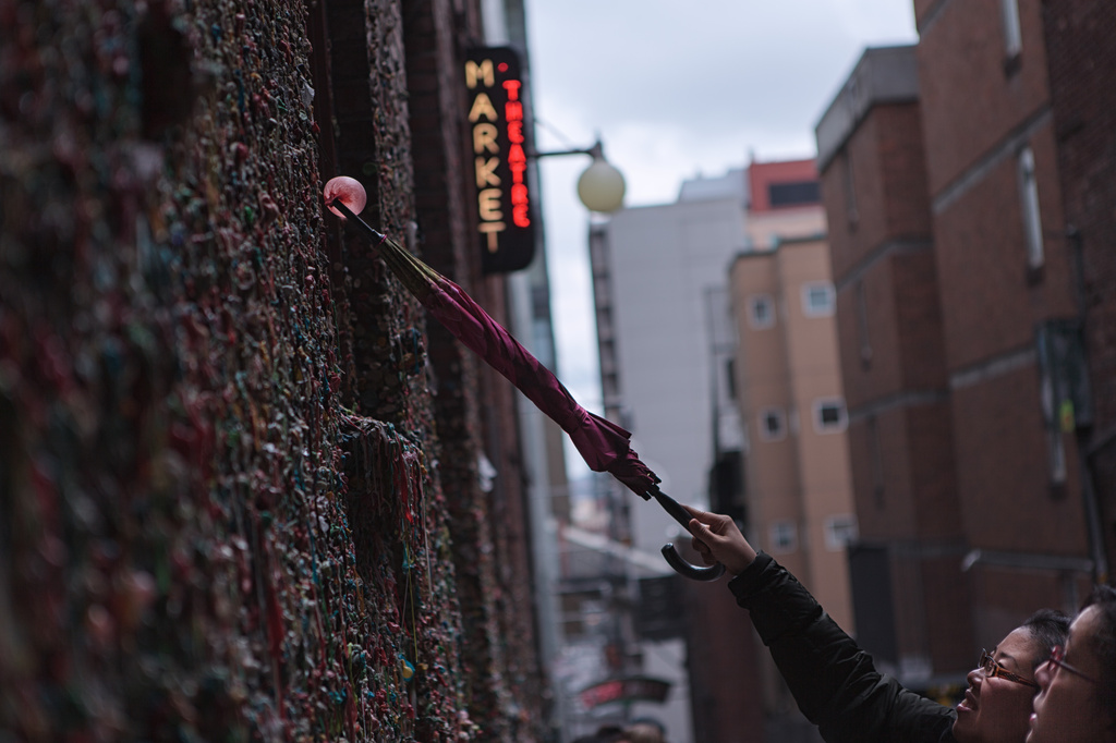 Placing The Gum On The Gum Wall At The Market by seattle