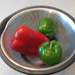 Red and Green Peppers in a Colander by april16