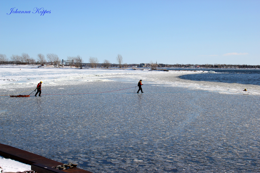 Rescue team out on the ice going towards... Our man in the Water. by hellie