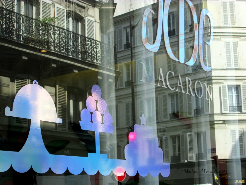 Reflection in a macaroons' window shop by parisouailleurs
