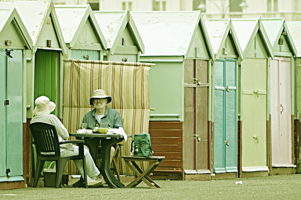 People Watching: Brighton Beach Huts by darrenboyj
