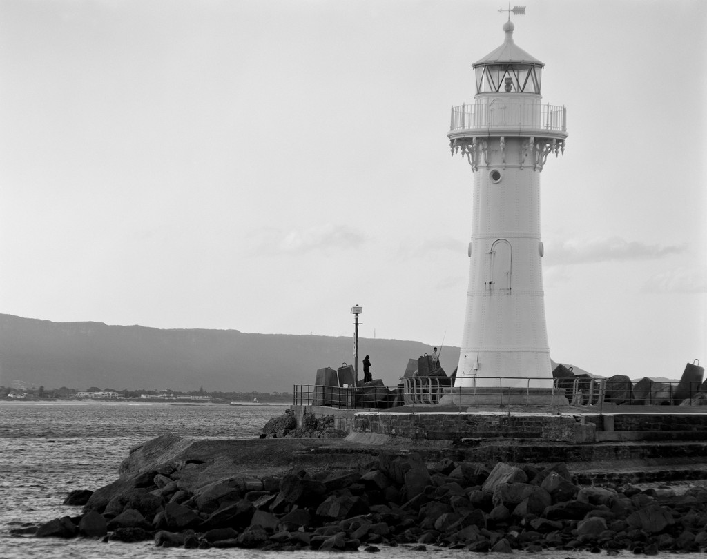 Fishermen and lighthouse by peterdegraaff