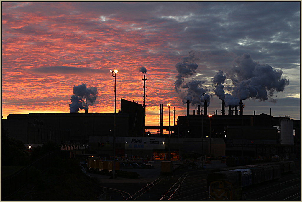 Steel mill at sunset by dide