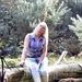 Woman sitting on a log by motorsports