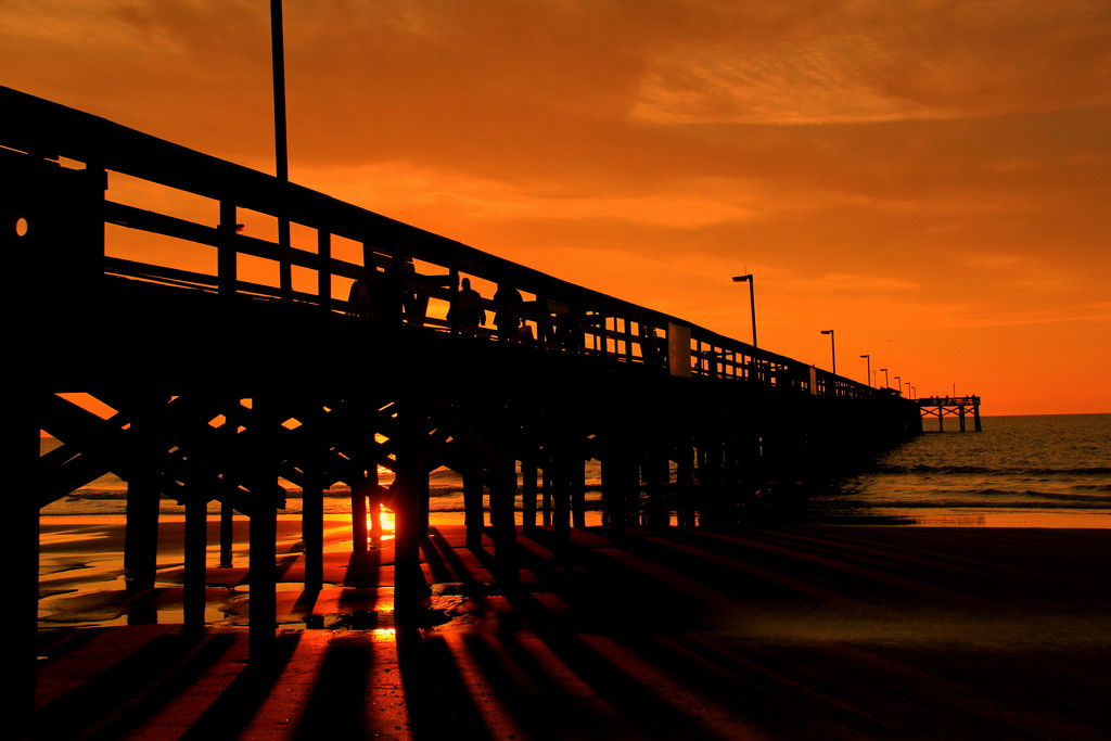 Sunrise Reflections Through The Pier by calm