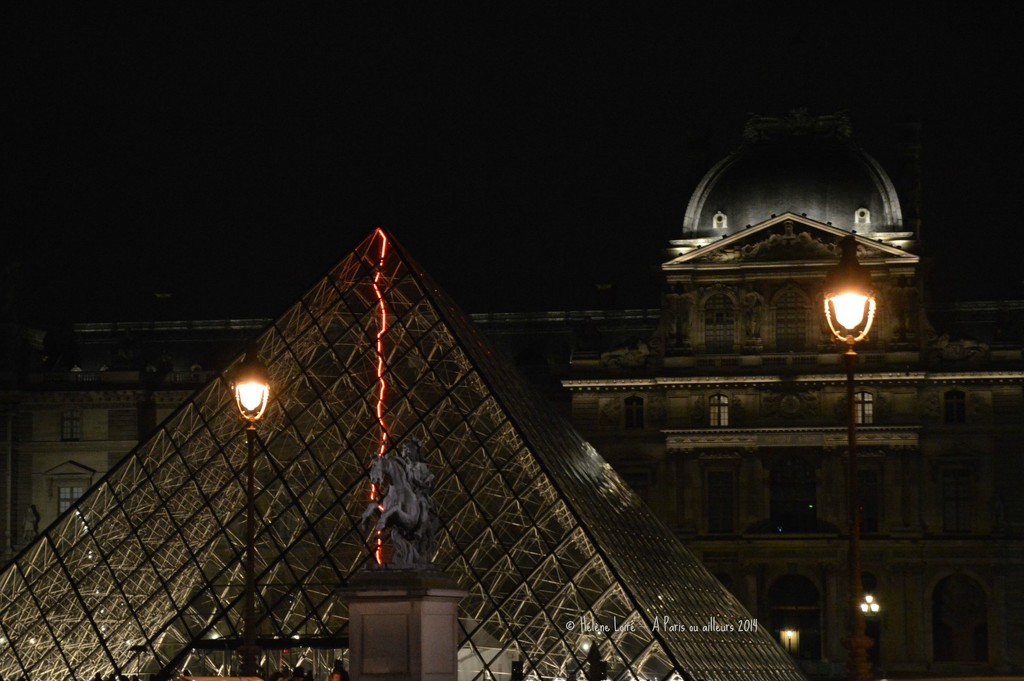 Red neon inside the Louvre Pyramid by parisouailleurs