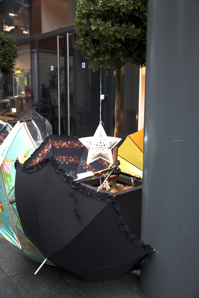 An umbrella or two for sale by padlock