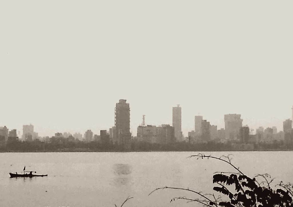 A silent reflection, a city buzzes...    6ws by amrita21