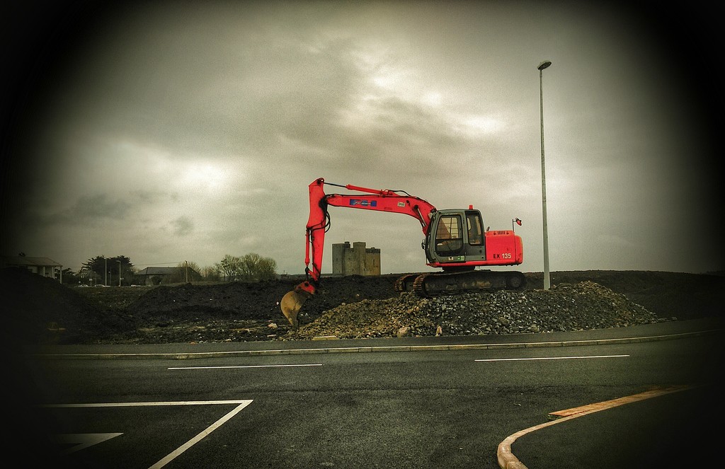 Oranmore Castle framed by the jib of a digger. by jack4john
