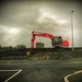 Oranmore Castle framed by the jib of a digger. by jack4john