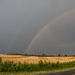 Rainbows over hay field by randystreat