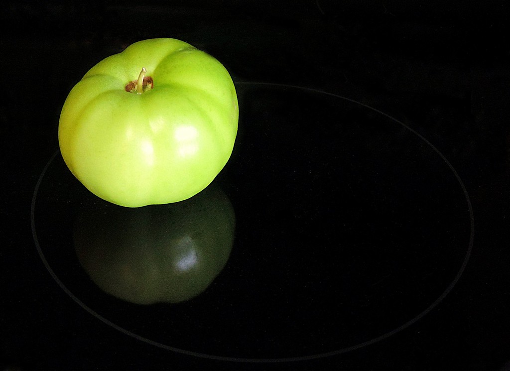 Reflections of a green tomato on my kitchen stove.... by homeschoolmom