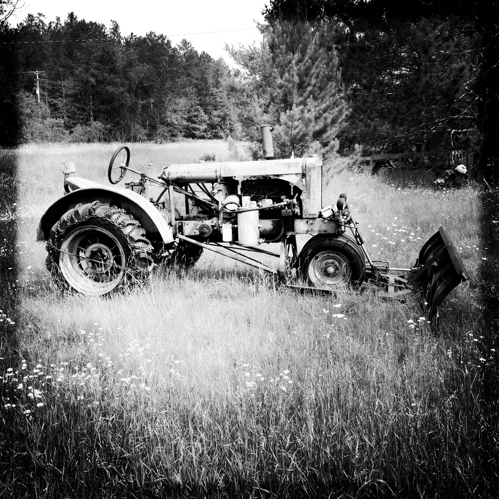 Old tractor during bike ride by jeffjones