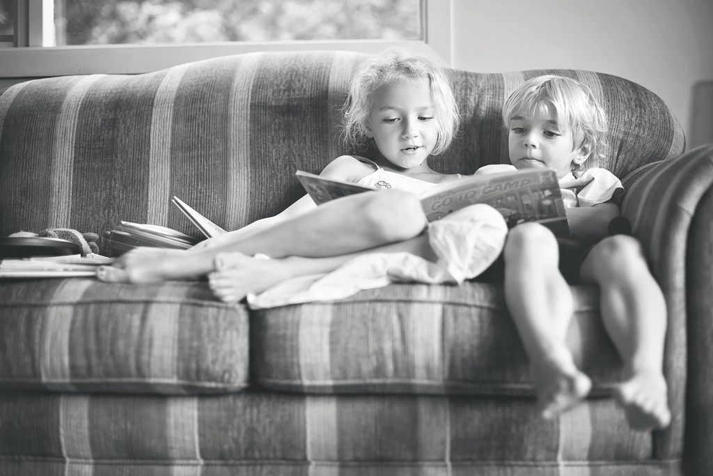 Reading stories to her little brother by kiwichick