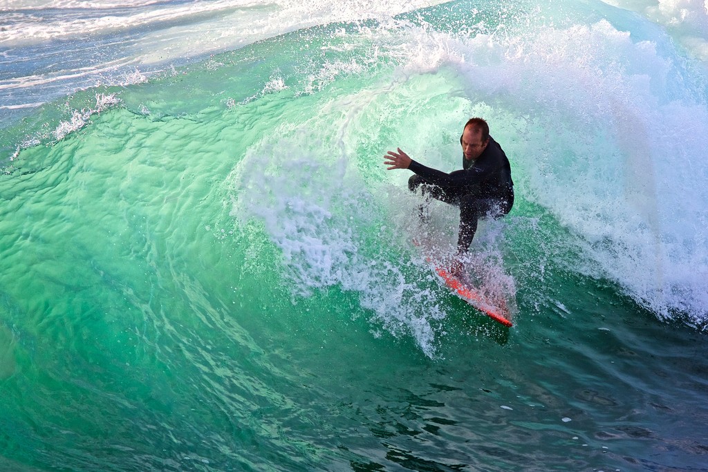Surfer inside the wave curl:  tighter crop by jyokota