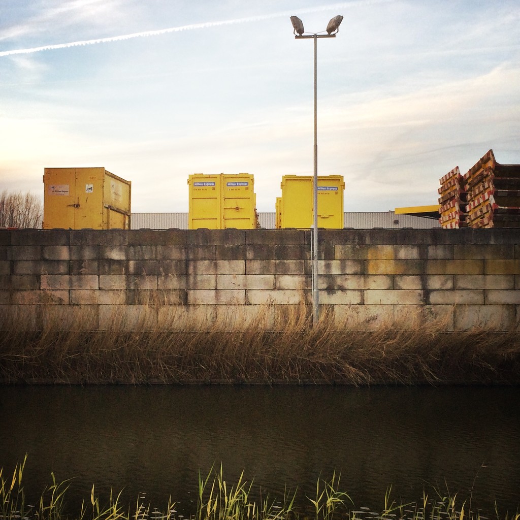Yellow containers behind lego brick wall by mastermek