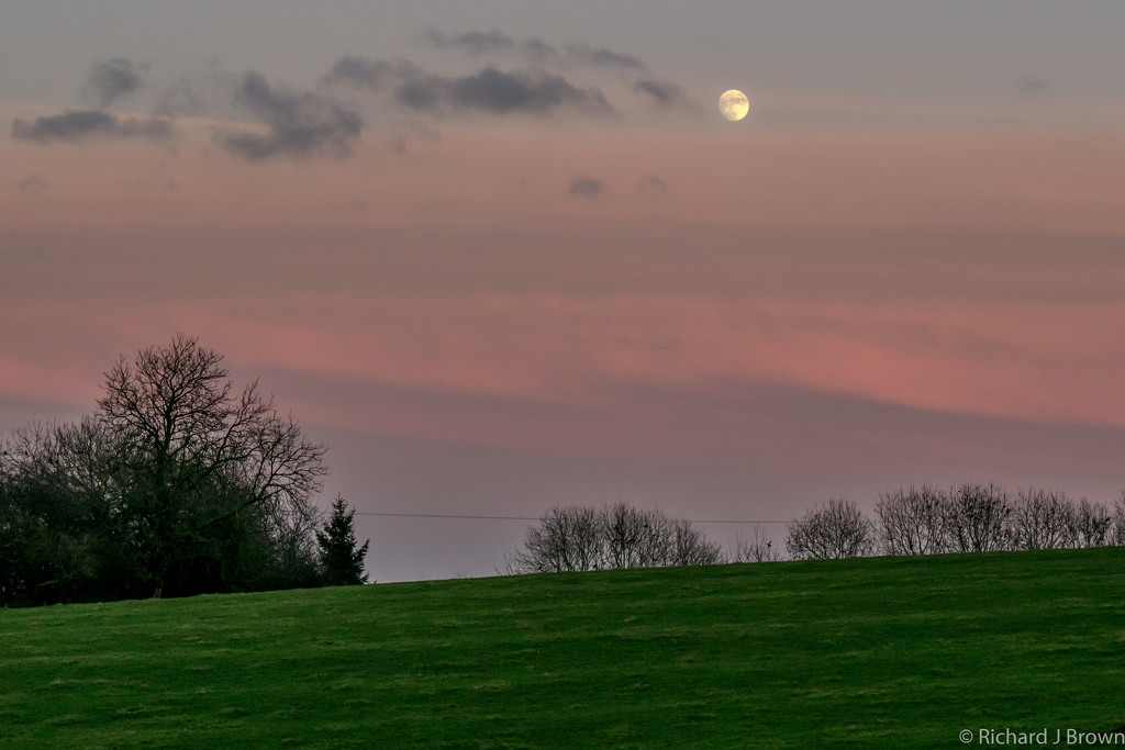 Moon rising as the Sun sets by rjb71