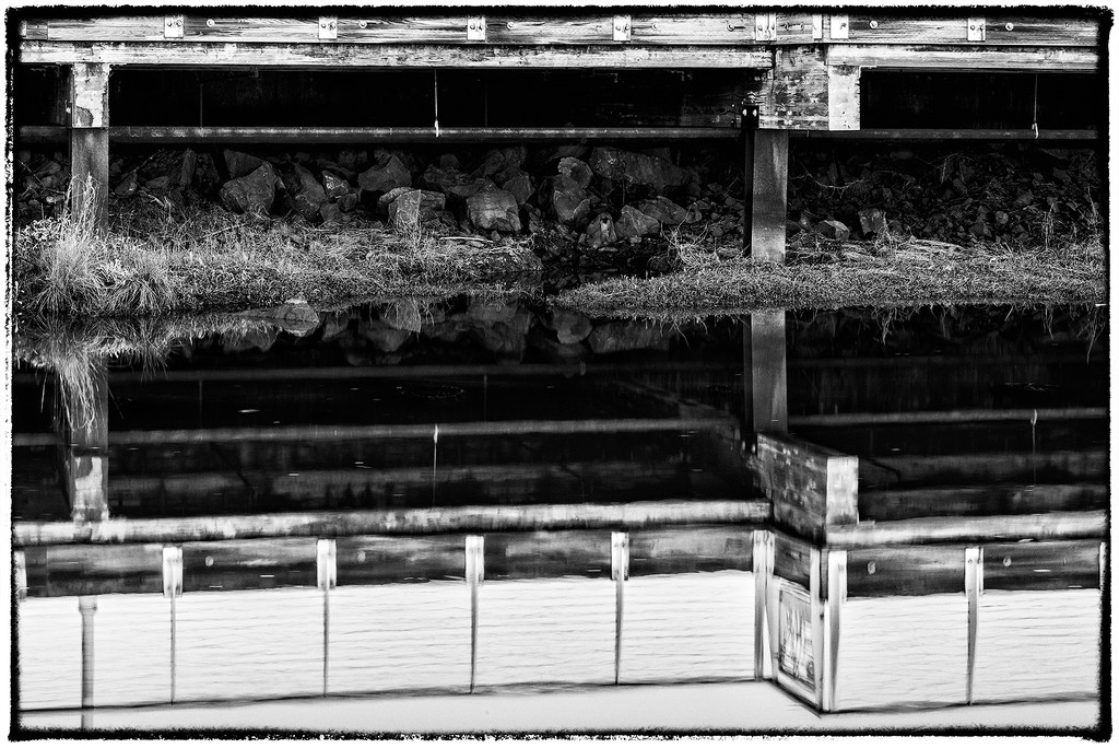 Black and WhiteUnder the Pier Reflections  by jgpittenger